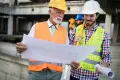 confident-team-of-architects-and-engineers-working-together-on-construction-site-e1600417590158